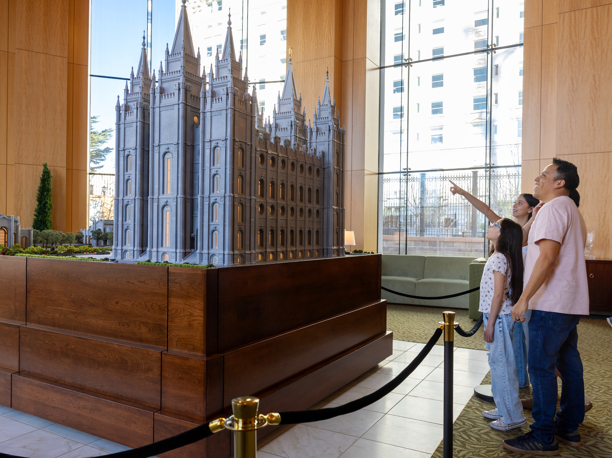 Family viewing a large detailed model of the Salt Lake Temple at the Visitor Center